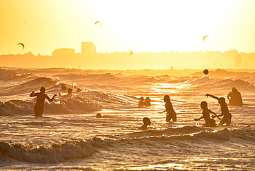 Many people bathing on the beach at sunset, beach Rambla, Montevideo, Uruguay, South America