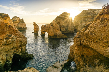 Rugged rocky coast, cliffs and arches in Ponta da Piedade at sunrise, Lagos, Algarve, Portugal, Europe