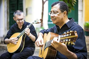 Two fado guitarists with acoustic and portuguese guitars in Alfama, Lisbon, Portugal, Europe