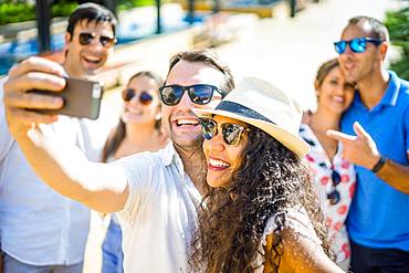 Two happy friends taking selfie in urban setting, Portugal, Europe