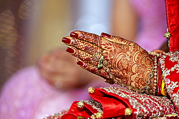 Traditional bridal jewelry and henna decoration on the hands of the bride during a religious ceremony at a Hindu wedding, Mauritius, Africa