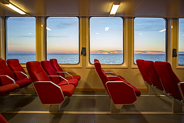 Red benches of a car ferry across the Gironde at sunset, Royan, Medoc, Gironde, France, Europe