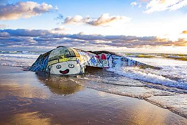 Colorfully painted bunker from the 2nd World War at high tide in the sea, Plage Gurp, Grayan-et-l`Hopital, Aquitaine, Gironde, France, Europe