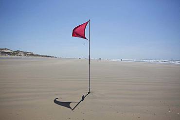 Red flag on the beach warn against dangerous drifts, Gurp Plage, Grayan-et-l`Hopital, Aquitaine, Gironde, France, Europe