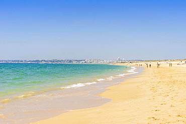 People relaxing on the beach next to Armacao de Pera, Algarve, Portugal, Europe