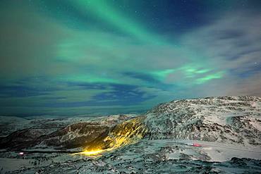 Northern Lights (aurora borealis), mountain landscape, winter landscape with view to the pass road on Jamnfjellet, Tromsoe, Norway, Europe