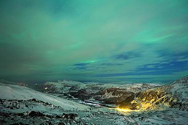 Northern Lights (aurora borealis), mountain landscape, winter landscape with view to the pass road on Jamnfjellet, Tromsoe, Norway, Europe