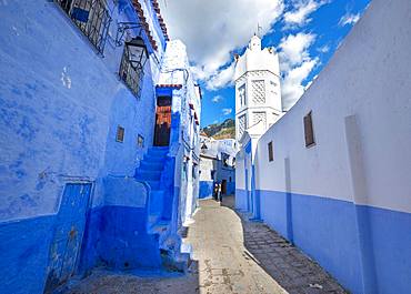 Minaret of a mosque, narrow lane between blue houses, Medina of Chefchaouen, Chaouen, Tanger-Tetouan, Morocco, Africa