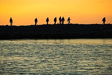 Backlit tourists, silhouette, sunset, Kobbefjord, Spitsbergen archipelago, Svalbard and Jan Mayen, Norway, Europe