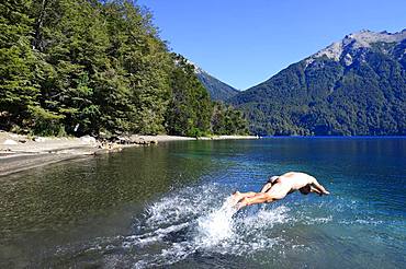 Naked man jumps headlong into cold water, Lago Traful, Province of Neuquen, Patagonia, Argentina, South America