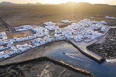 Caleta de Famara at sunset, drone shot, Lanzarote, Canary Islands, Spain, Europe