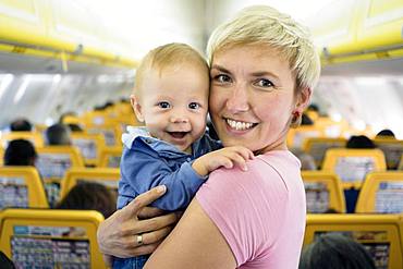 Mother with her six months old baby boy in the airplane, Spain, Europe