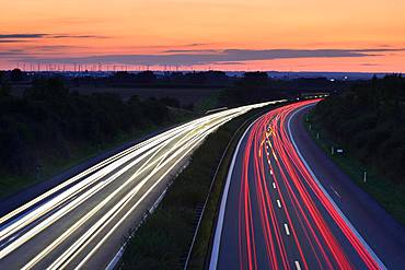 Light tracks on the A14 motorway at dusk, near Halle an der Saale, Saxony-Anhalt, Germany, Europe