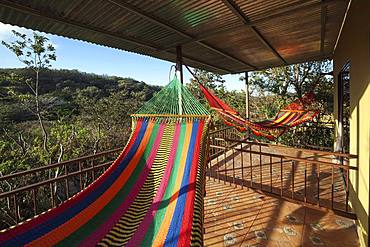 Colourful hammocks on the terrace, Rinconcito Lodge at Rincon de la Vieja National Park, near Liberia, Guanacaste Province, Costa Rica, Central America