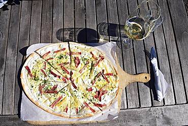 Pfaelzer Flammkuchen with ham and paprika and a glass of white wine, German Wine Route, Rhineland-Palatinate, Germany, Europe