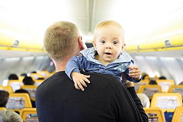 Father with his six months old baby boy in the airplane, Spain, Europe