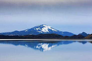 Reflection of the snow-covered volcanic cone Hekla in Hrauneyjalon, South Iceland, Iceland, Europe