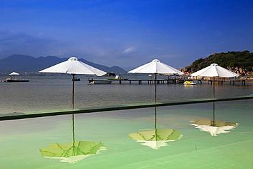 Swimming pool with parasols, Sao Bien holiday resort in the bay of Cam Ranh, South China Sea, Ninh Thuan, Vietnam, Asia