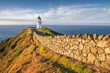 Away with stone wall leads to the lighthouse at Cape Reinga, Far North District, Northland, North Island, New Zealand, Oceania