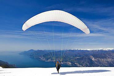 Launch of a paraglider on Monte Baldo above Lake Garda, Malcesine, Veneto, Italy, Europe