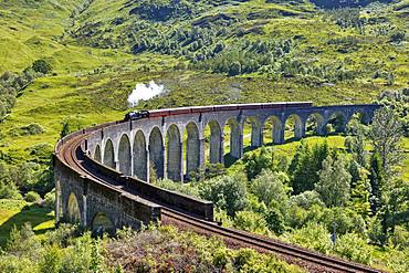 Glenfinnan viaduct from the Harry Potter films with historic train, Jacobin Express, Glenfinnan, Scotland, Great Britain