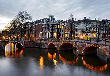 Canal with bridge at dusk, Keizersgracht and Leidsegracht, Amsterdam, North Holland, Netherlands