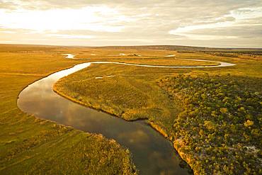 Aerial view, Cuanavale river meanders through grass savannah, near Cuito Cuanavale, Cuando Cubango Province, Angola, Africa