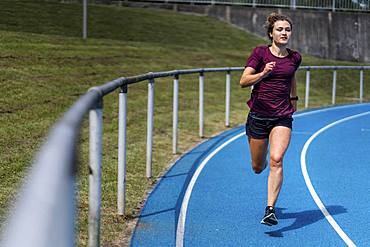 Athletics, woman sprinting in the curve, Germany, Europe