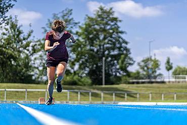 Athletics, woman sprinting, start from start block, Germany, Europe