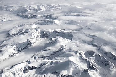 View from the plane to snow-covered mountainous landscape, bird's eye view, Greenland, North America