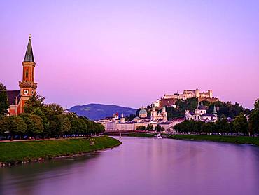 City view, old town and fortress Hohensalzburg over the river Salzach at dusk, Salzburg, Land Salzburg, Austria, Europe