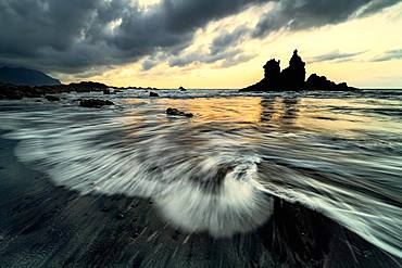 Dramatic cloud atmosphere with rock formation at sunset on the beach of Playa de Benijo, Canary Island, Tenerife, Spain, Europe