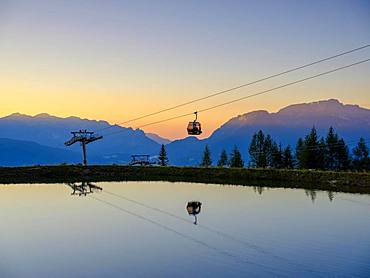 Alpine panorama, gondola of the Jennerbahn cable car reflected in the evening light in an artificial mountain lake, Jenner, Berchtesgadener Alps, Schoenau am Koenigssee, Berchtesgadener Land, Upper Bavaria, Bavaria, Germany, Europe