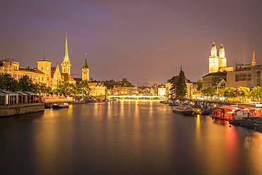 View over river Limmat at dusk, old town with Fraumuenster, St. Peter and Grossmuenster, old town, Zurich, Switzerland, Europe