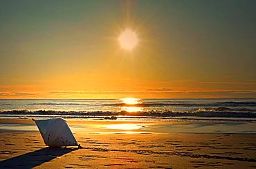 Buoy lying on the beach, sunset, Saint Peter Ording, North Sea, Schleswig-Holstein, Germany, Europe