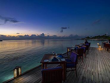 Sunset on the beach with restaurant on Maldives island South Male Atoll, Maldives, Asia