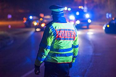 Police officer regulates traffic in a traffic accident, Stuttgart, Germany, Europe