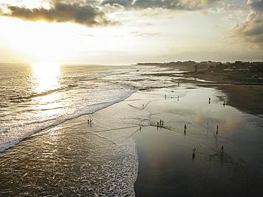 Aerial view, Black volcanic beach with waves running out in the sunset, walker, Canggu Beach, Bali, Indonesia, Asia