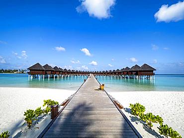 Footbridge over shallow water to water bungalows, island in South Male Atoll, Maldives, Asia