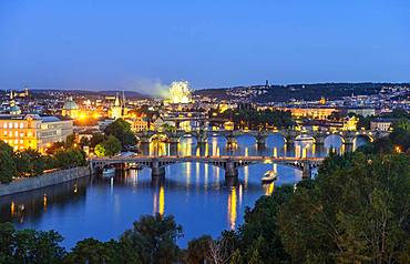 City view, bridges over the river Vltava, Charles Bridge with Old Town Bridge Tower and Water Tower, back fireworks, evening mood, Prague, Bohemia, Czech Republic, Europe