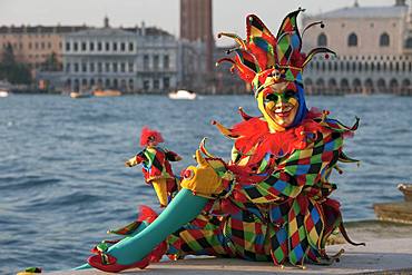 Harlequin, Carnival in Venice, background Doge's Palace, Venice, Italy, Europe