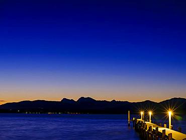 Footbridge at Chiemsee at dawn, behind the Chiemgau Alps, Chiemgau, Upper Bavaria, Bavaria, Germany, Europe