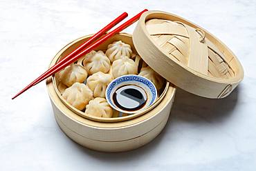 Dim Sum, filled dumplings, steamed in bamboo baskets with soy sauce and chopsticks, Germany, Europe