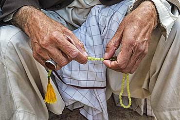 Muslim man with his sabha in Mozaffari Jame Mosque or Friday Mosque, Kerman, Kerman Province, Iran, Asia