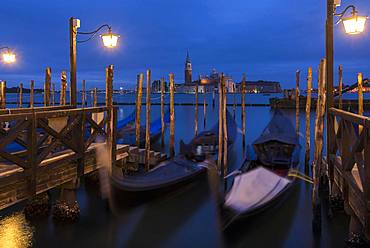 Nocturnal atmosphere with moving gondolas, San Georgio Maggiore in the back, Guidecca Island on the right, Venice, Italy, Europe