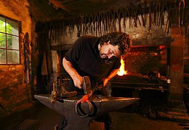 Blacksmith at the anvil, hammer mill Burghausen, Upper Bavaria, Bavaria, Germany, Europe