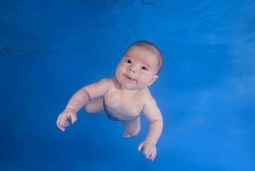 Little boy, baby, learns to swims underwater, Russia, Europe