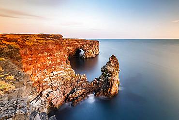 Steep coast with rock formations at Oendverdarnes, long exposure, Oendveroarnes, Snaefellsjoekull National Park, Snaefellsnes Peninsula, Snaefellsnes, Vesturland, Iceland, Europe