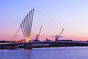 Media City footbridge and victorian cranes in afterglow, Salford Quays, Manchester, UK