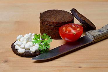 Pumpernickel disc covered with cream cheese, Germany, Europe